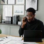 Man in Black Jacket Using Black Laptop Computer