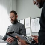 Man in Black Long Sleeve Shirt Holding Black Tablet Computer